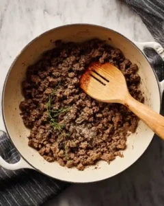 Ground beef browning in soup pot with spices