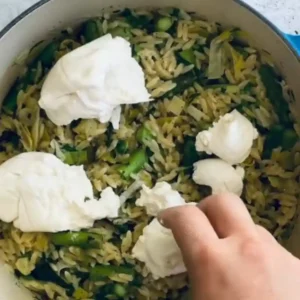 Adding fresh burrata cheese to the one-pot orzo risotto spring veggies for a creamy finish.