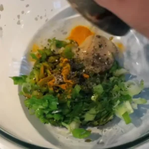 A white bowl containing a golden-yellow marinade made from miso and turmeric.