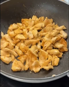 One Pan Chicken with Buttered Noodles Recipe: Cooking chicken pieces in a skillet with butter.