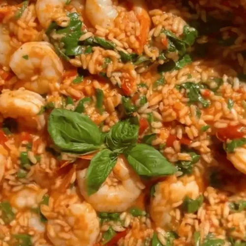 Finished One-Pan Salsa Verde Shrimp and Rice garnished with fresh basil and spinach.
