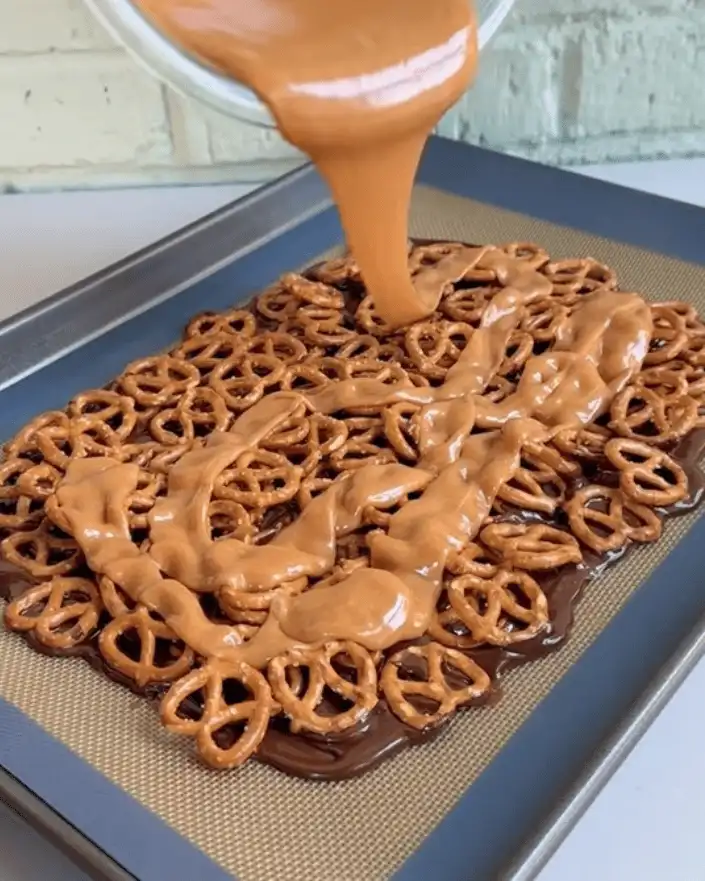 caramel sauce poured over pretzels for no bake caramel pretzel crack bars