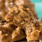 Close-up of chewy no bake coconut pecan praline cookie with a bite taken