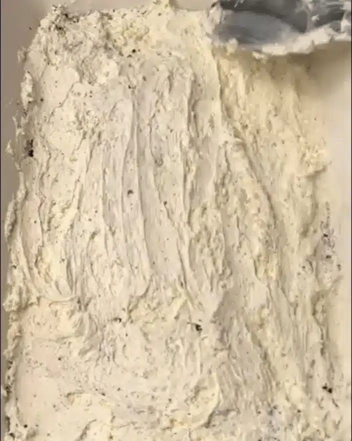 Spreading cheesecake layer in No Bake Shamrock Shake Dessert