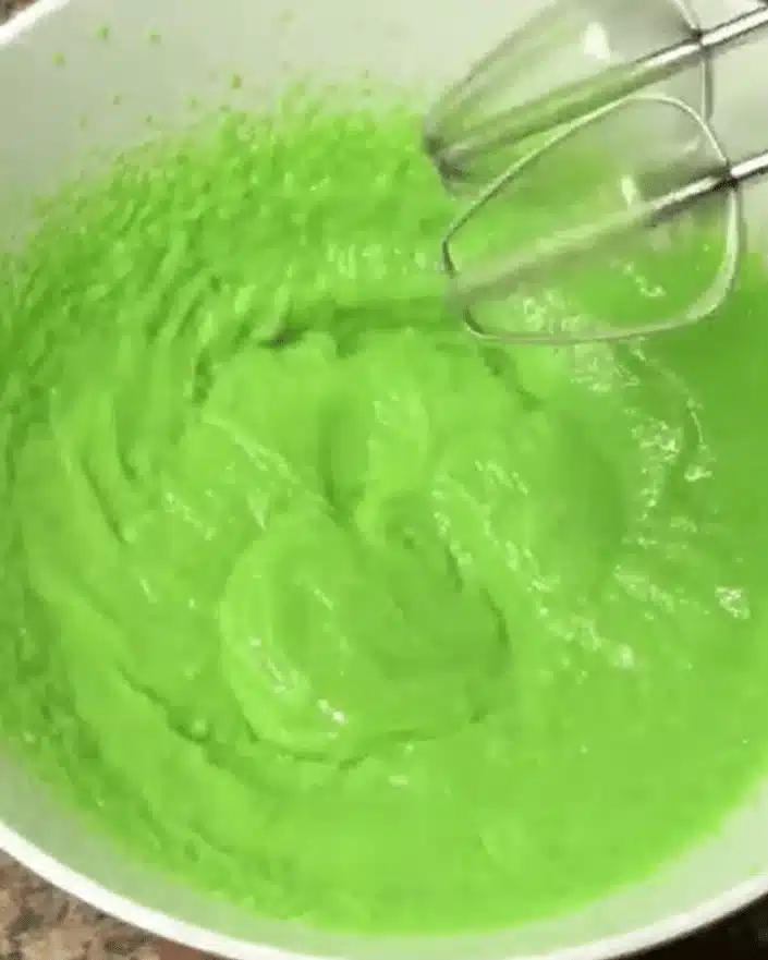 Mixing green pudding layer for No Bake Shamrock Shake Dessert