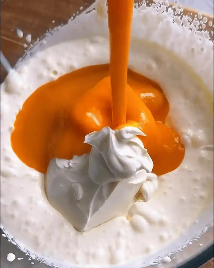 Mixing mango puree and cream cheese for no bake mango cheesecake cups