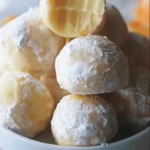 finished no bake orange creamsicle truffles dusted with powdered sugar