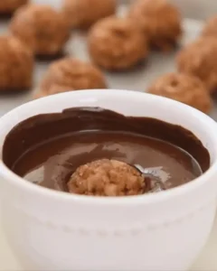 dipping pecan pie balls no bake into melted chocolate