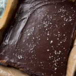 no-bake date caramel brownie batter bars stacked on board