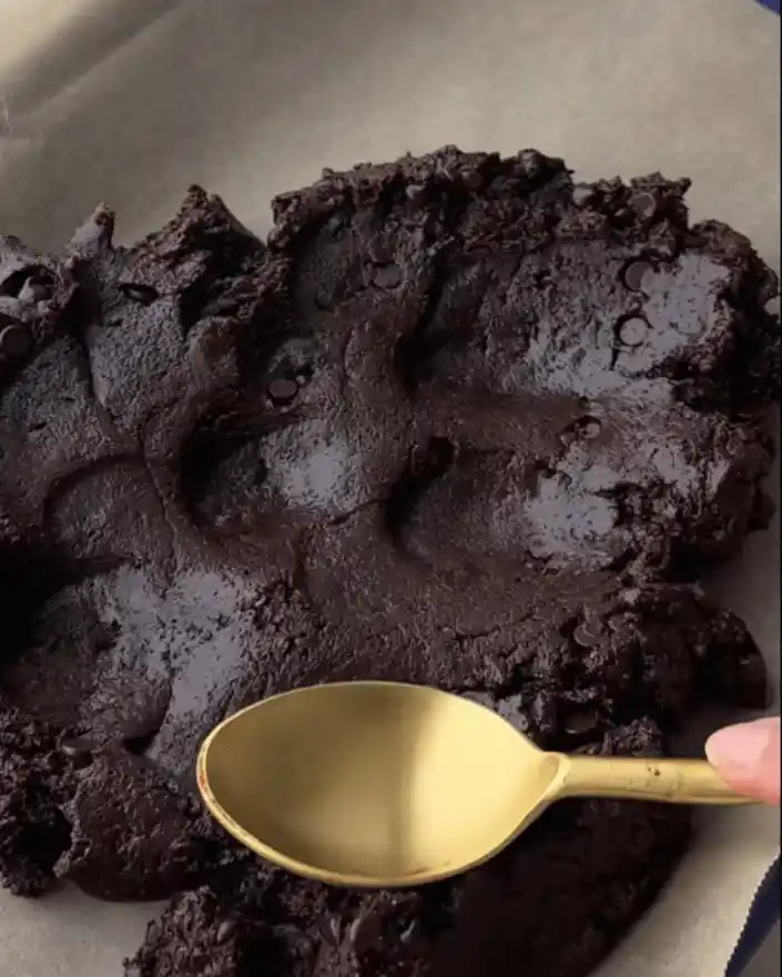 Pressing brownie mixture into baking pan for no bake healthier brownies recipe