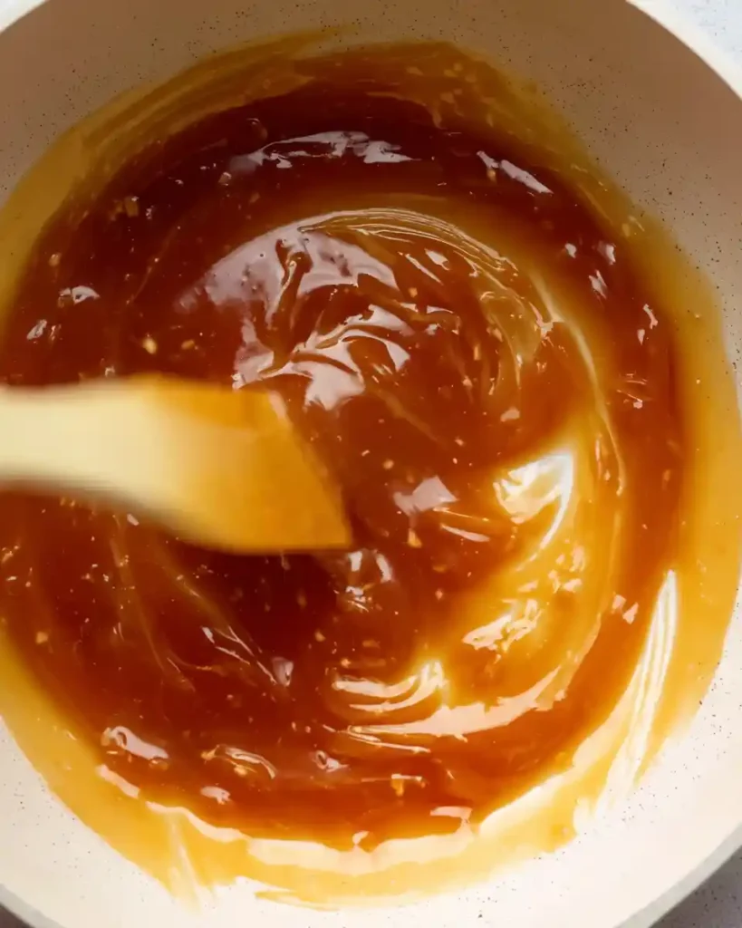 Homemade Caramel Sauce 3 Sugar melting into golden caramel in saucepan